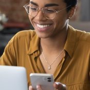 vrouw achter laptop blij over digitale toegankelijkheid als conversiebooster